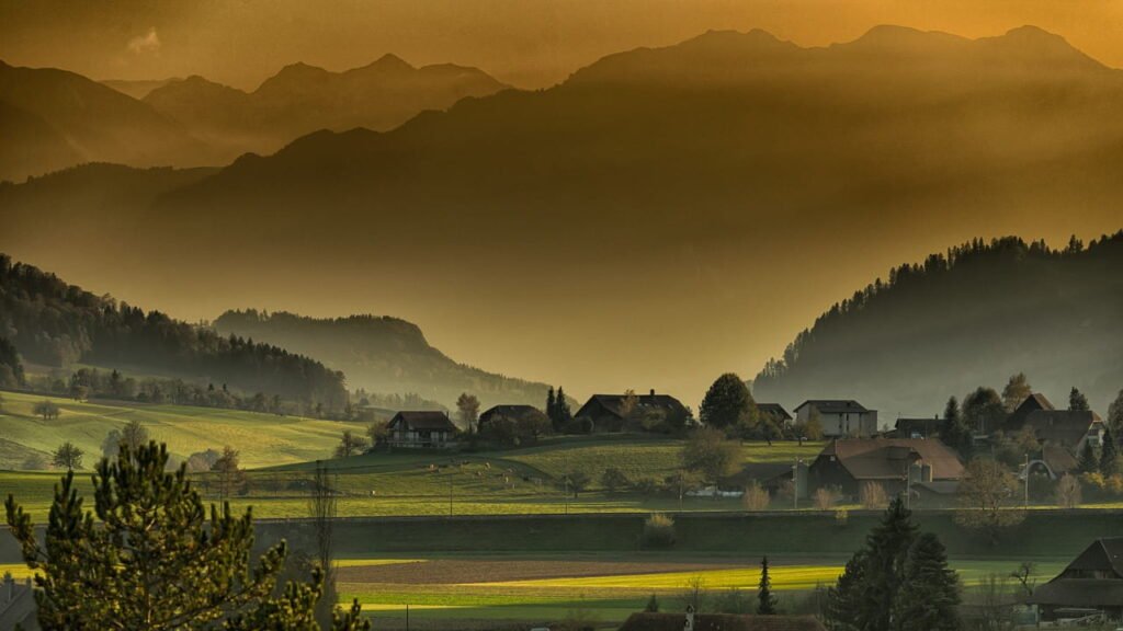 A small town in the mountains at sunset